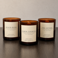 KMAS Signature Candle Bundle featuring The Lounge, Cabin Cookies and Beach Bliss hand-poured coconut wax candles with wooden wicks.