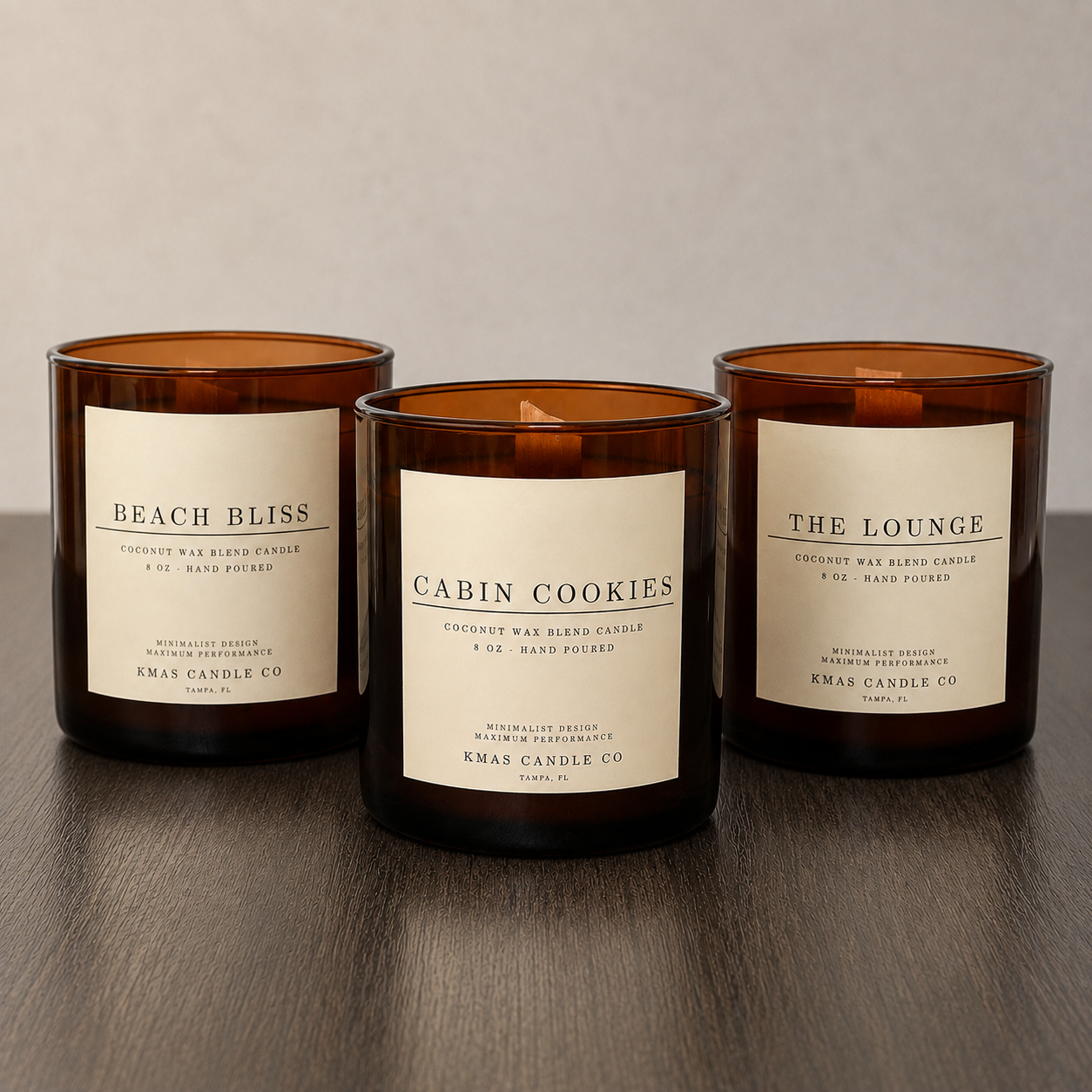 KMAS Signature Candle Bundle featuring The Lounge, Cabin Cookies and Beach Bliss hand-poured coconut wax candles with wooden wicks.